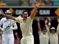 Australia fast bowler Mitchell Johnson (C) celebrates the dismissal of England's Stuart Broad (L) on day four of the first Ashes Test match at the Gabba Cricket Ground in Brisbane on November 24, 2013