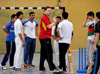 Brian Mantle (C), President of the Deutscher Cricket Bund (DCB) oversees a training session with refugees from Afghanistan in Essen, western Germany.