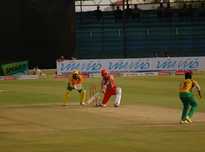KP Appanna bowling to SP Manjunath as wicket-keeper Robin Uthappa looks on.