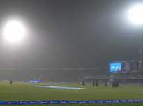 Pakistani cricketers leave the ground amid a sandstorm.