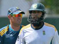 South Africa cricket team captain Hashim Amla (R) and team coach Russel Domingo pictured during a practice session at the R. Premadasa International Cricket Stadium in Colombo on July 23, 2014