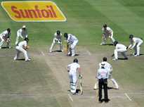 South Africa's Kyle Abbott (centre) is surrounded by Australian fielders on the fifth and final day of the third Test at Newlands in Cape Town, on March 5, 2014