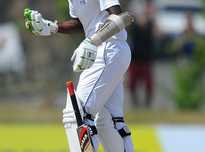 Sri Lankan Cricketer Shaminda Eranga checks his hand after being hit by the ball.