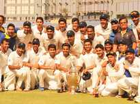 The victorious Karnataka team pose with the Ranji Trophy.